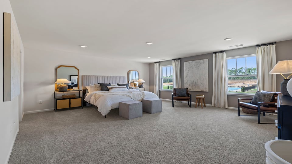 Bedroom with carpet and windows.