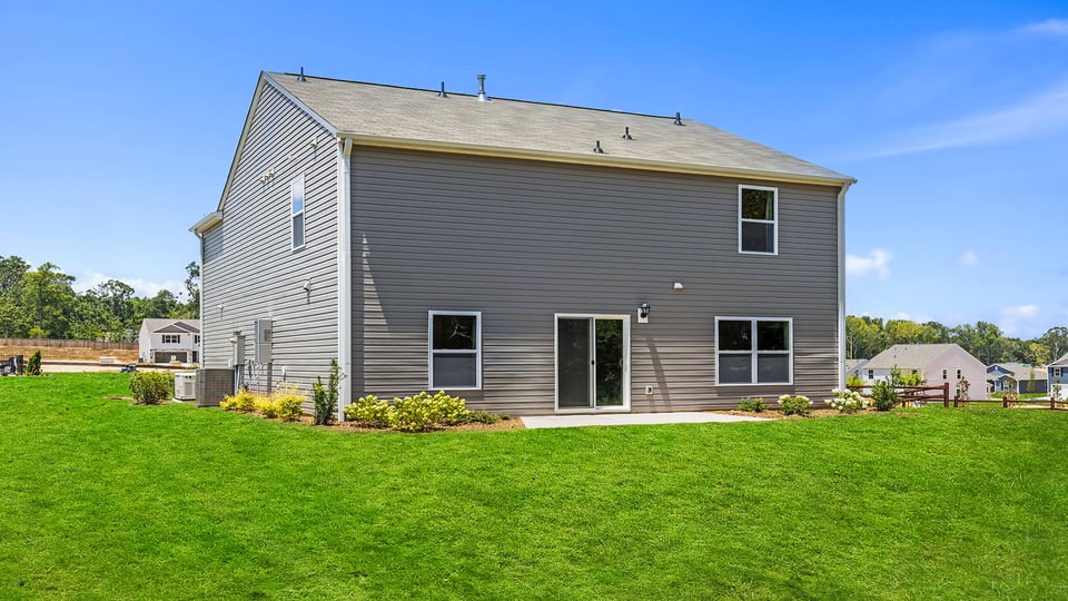 Exterior of home with large backyard.