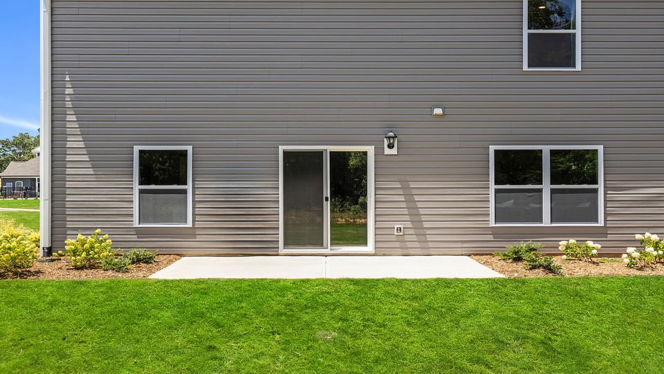 Exterior of home with large backyard.