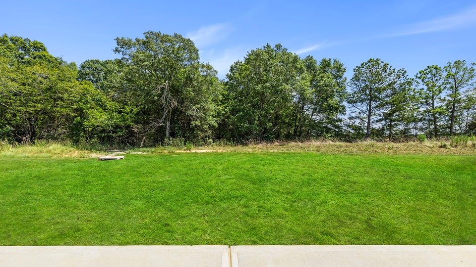 Exterior of home with large backyard.