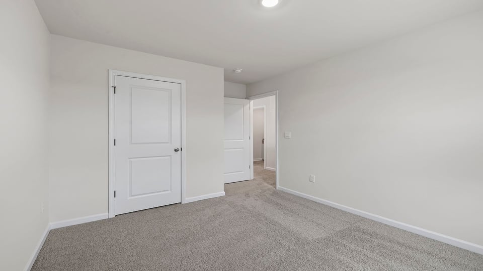 Bedroom with carpet and winsows.