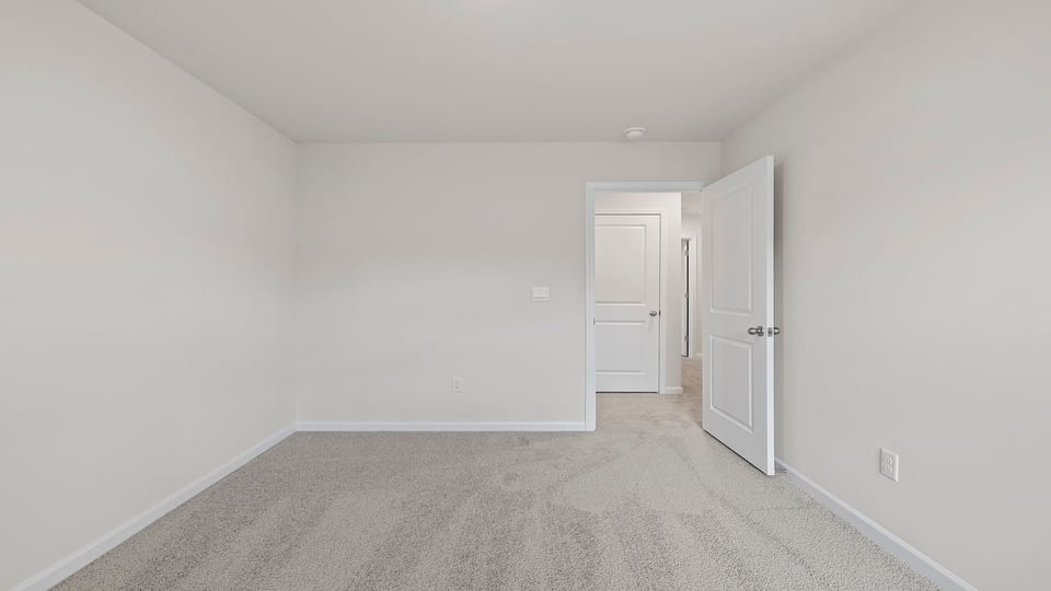 Bedroom with carpet and winsows.