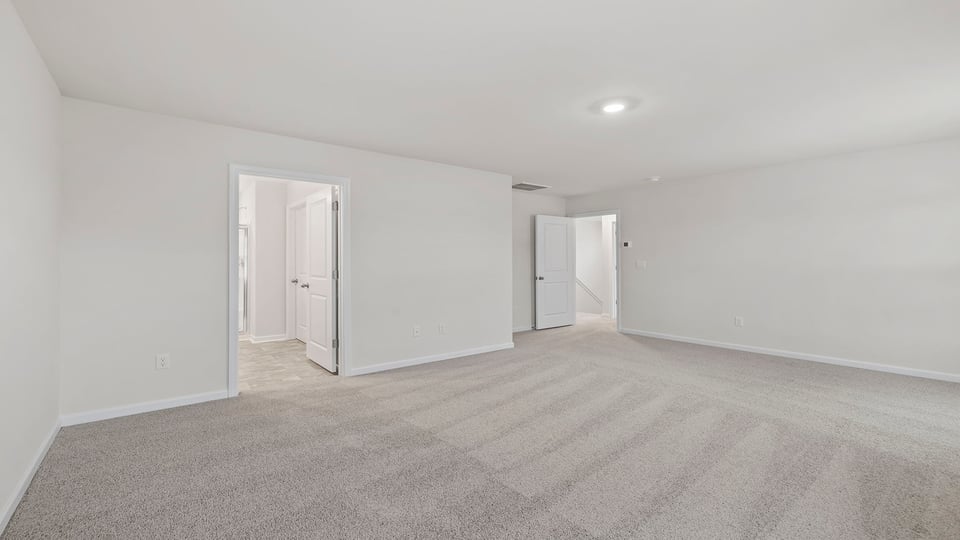 Bedroom with carpet and winsows.