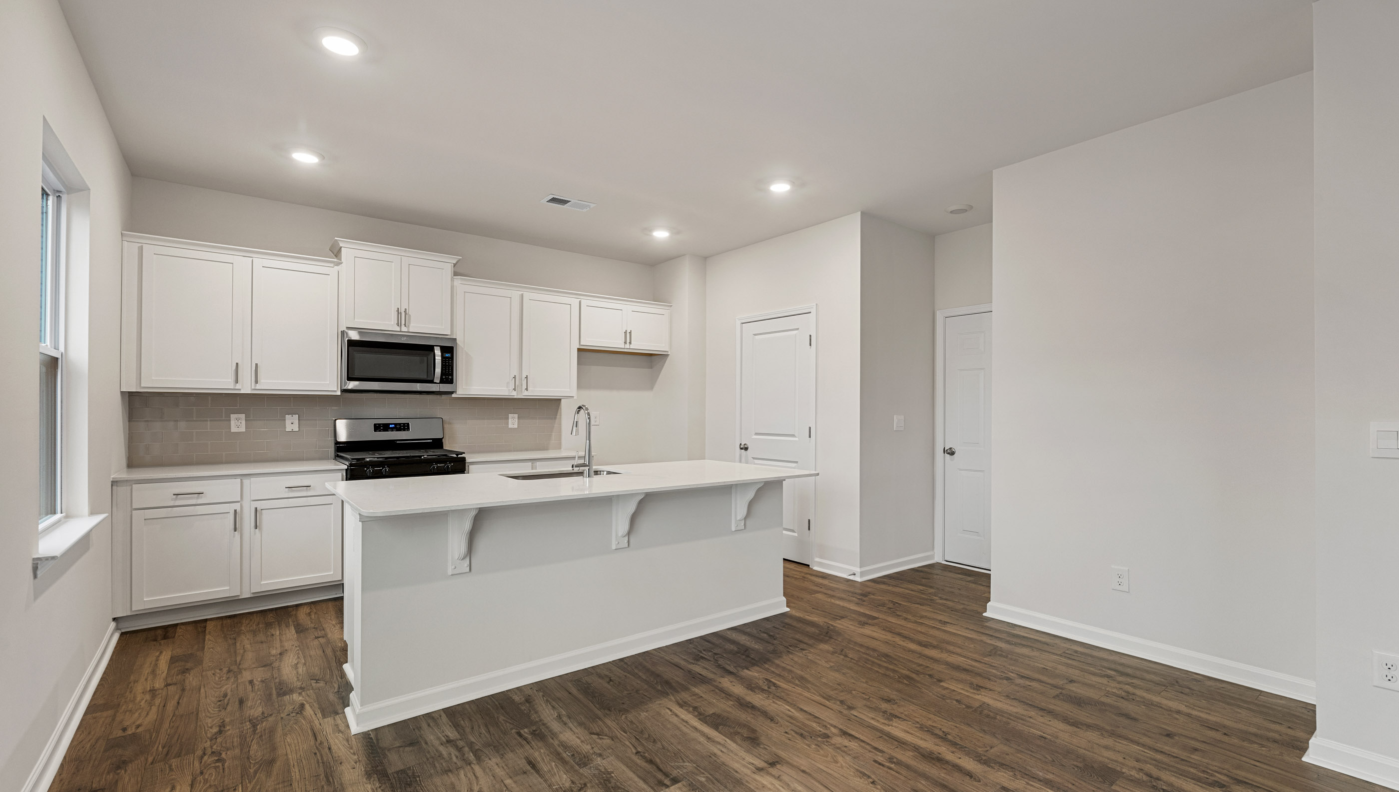 Kitchen and island with granite counter tops.