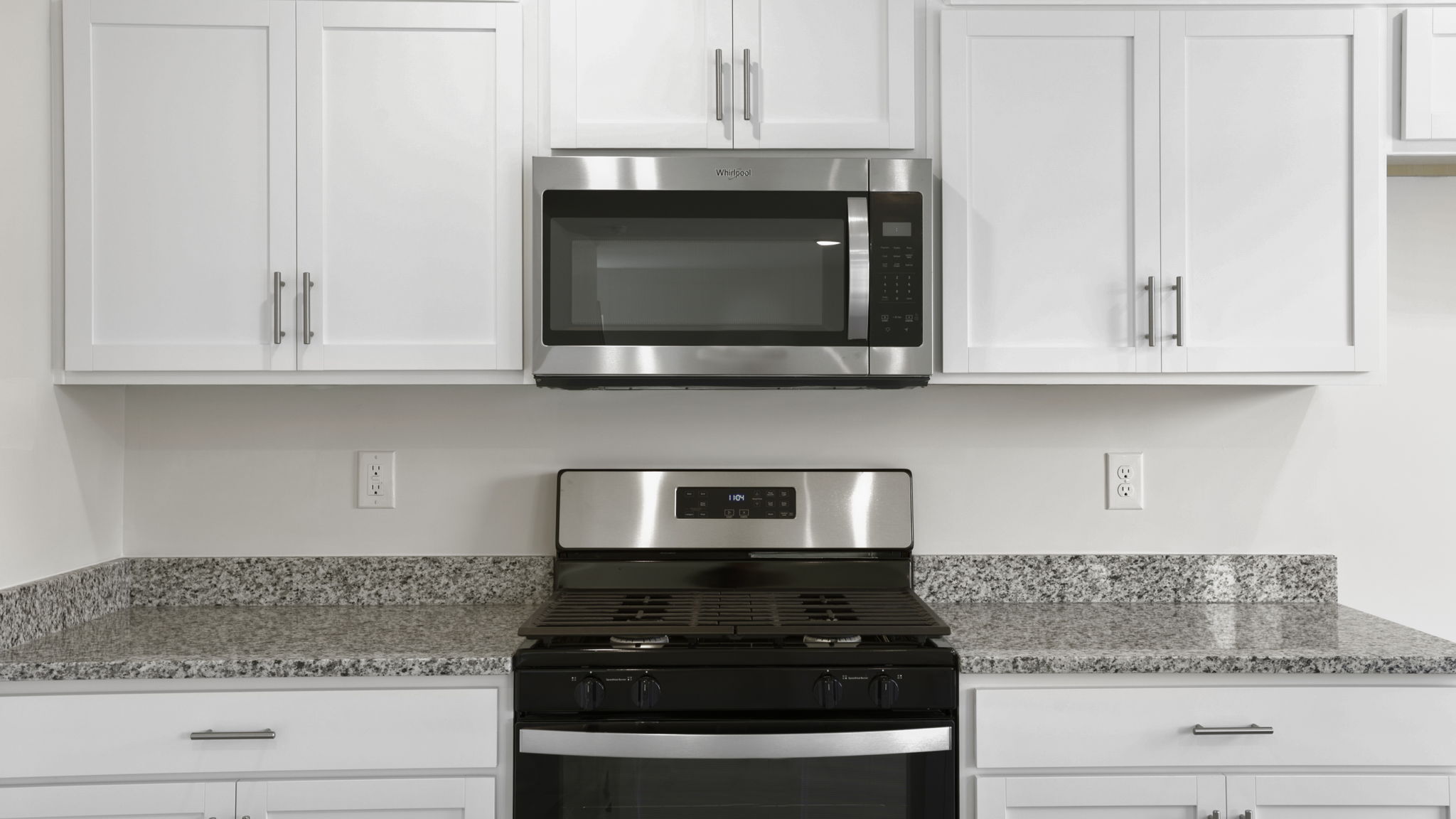 Kitchen with quartz countertops and stainless steel appliances.