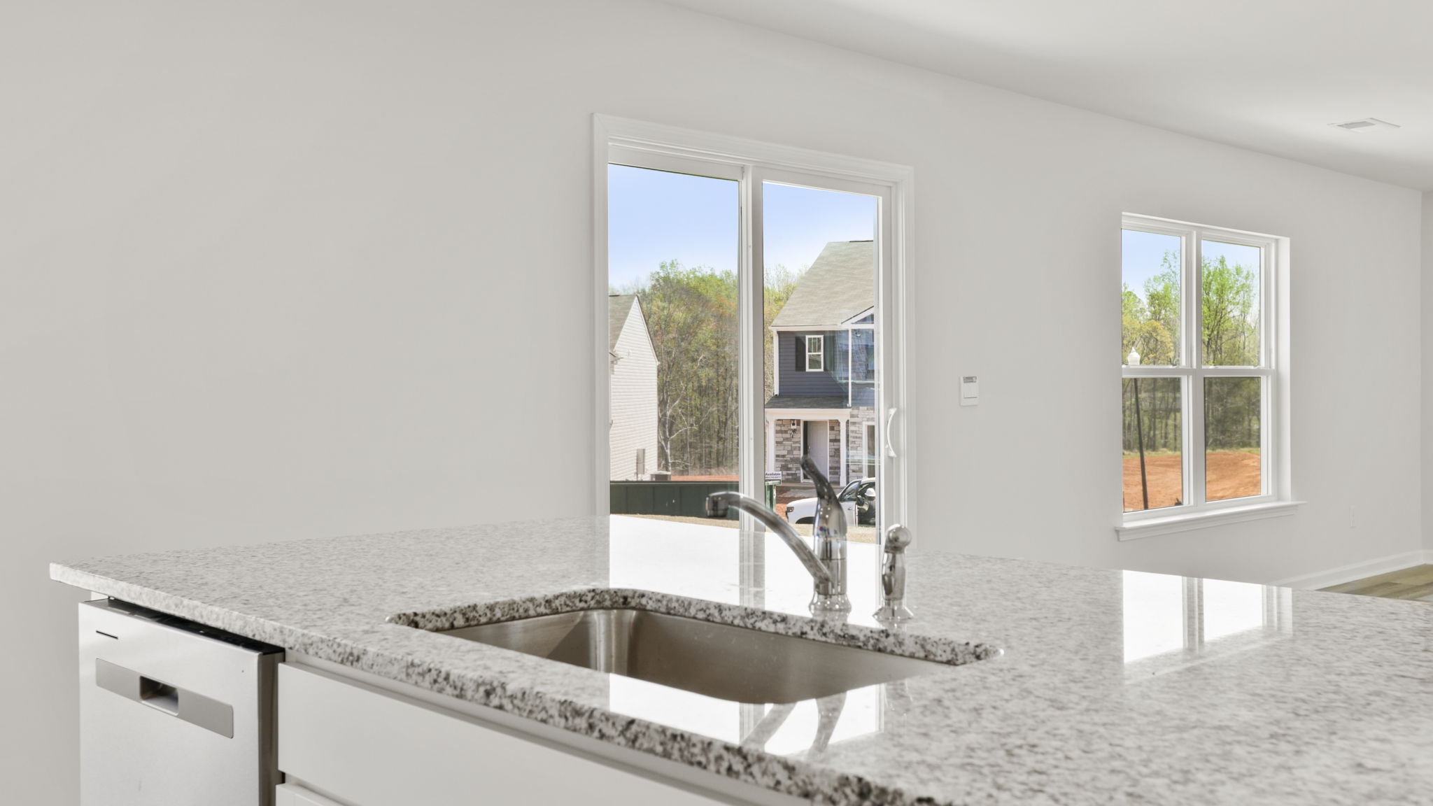 Kitchen with quartz countertops and stainless steel appliances.