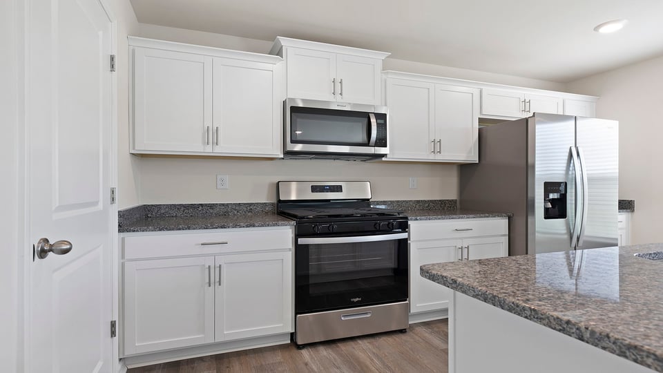 Kitchen with island and stainless steel appliances.