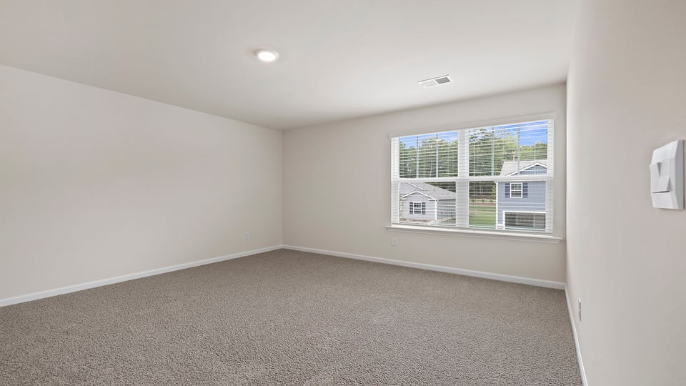 Bedroom with carpet and window.