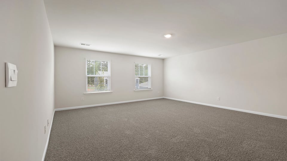 Bedroom with carpet and window.