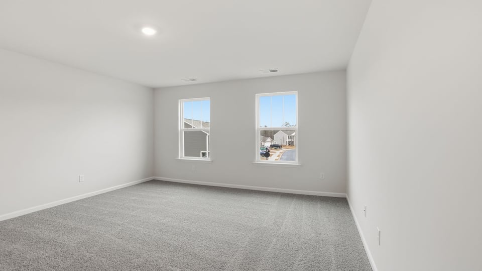 Bathroom with carpet and windows.