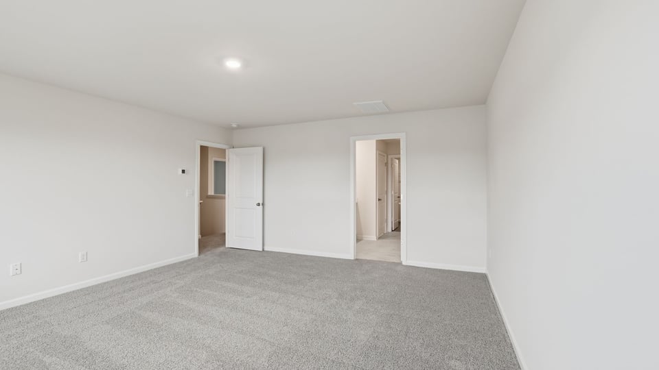 Bathroom with carpet and windows.