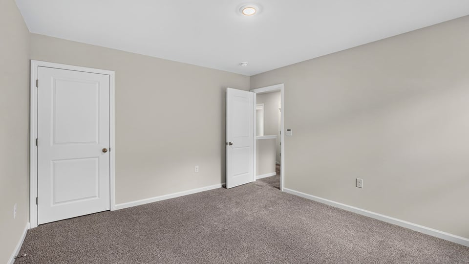 Bedroom with carpet and window.