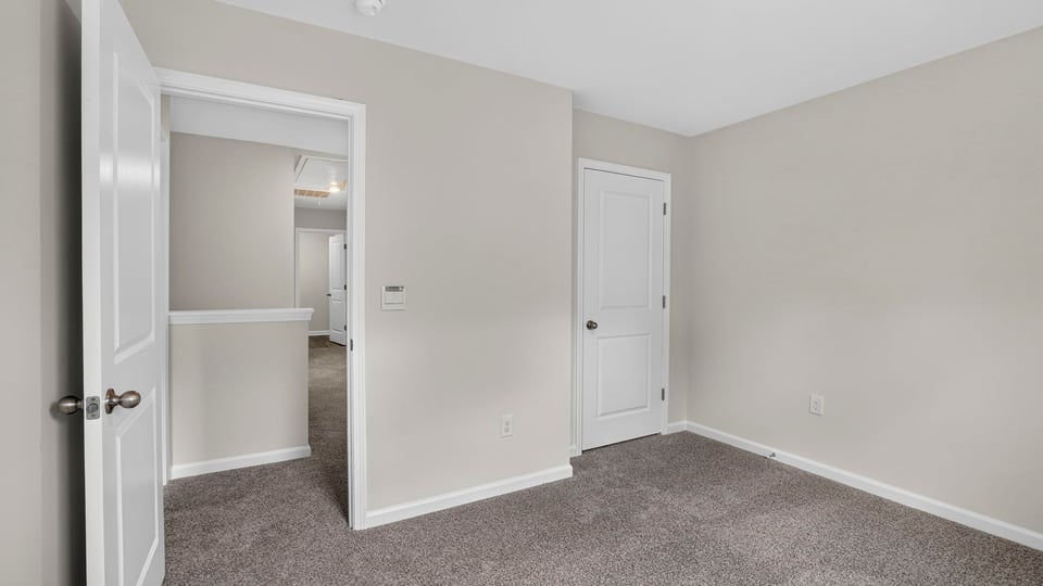 Bedroom with carpet and window.