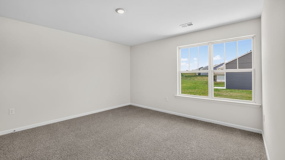 Bedroom with carpet and window.