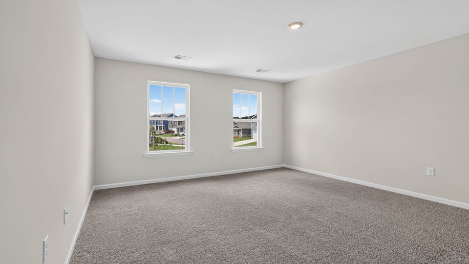 Bedroom with carpet and window.