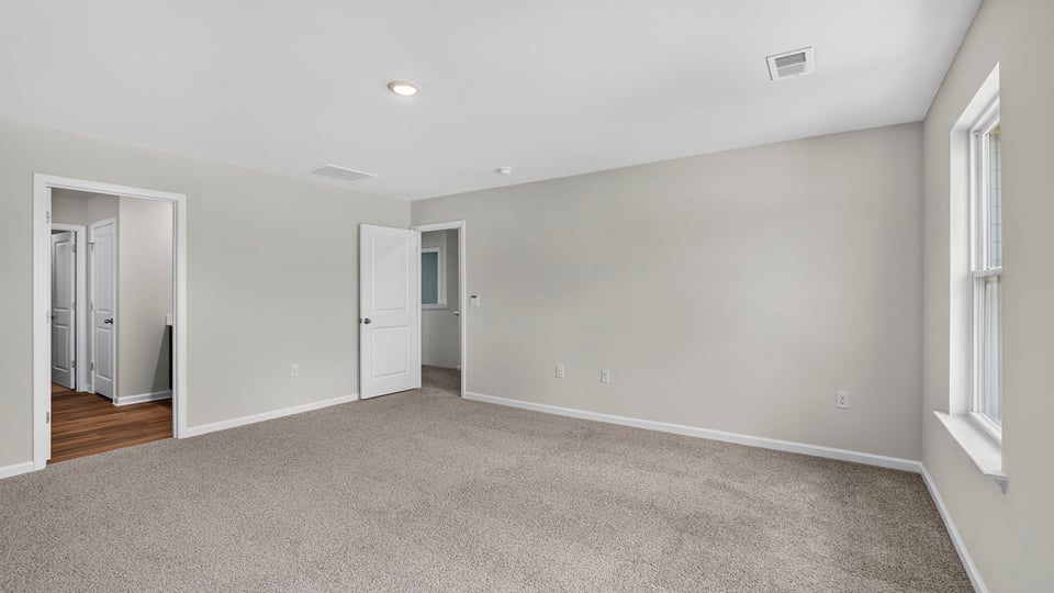 Bedroom with carpet and window.
