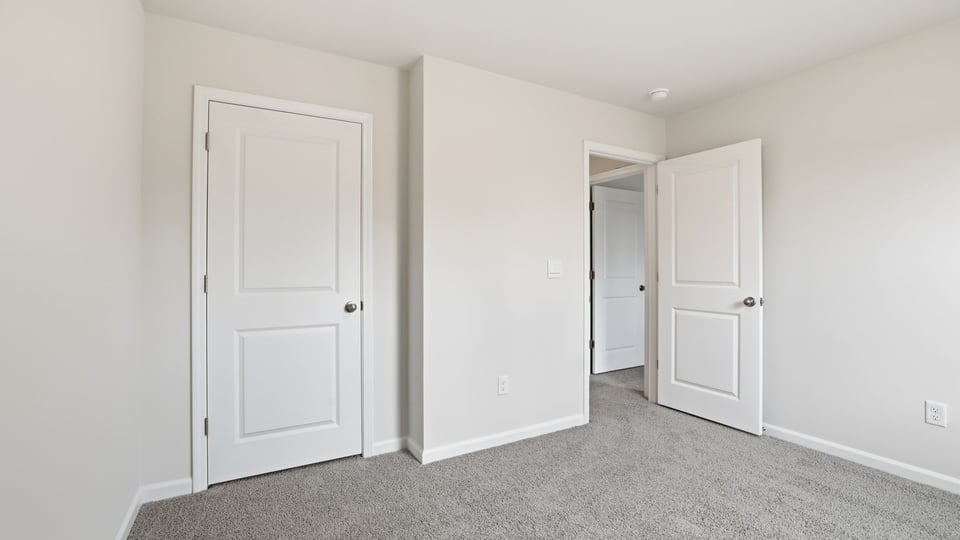 Bedroom with carpet and window.
