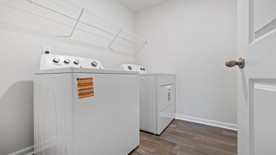 Walk in laundry with shelves.