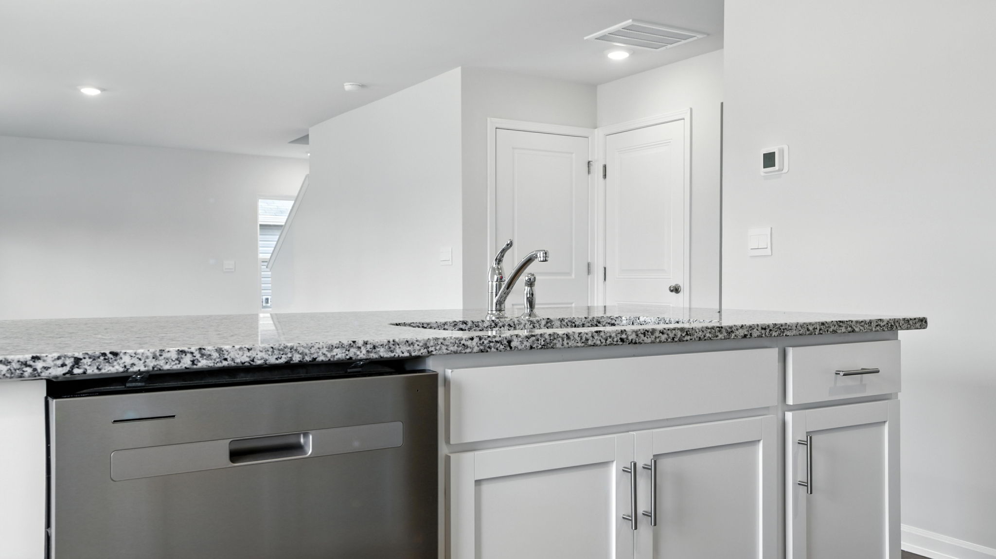Kitchen and island with granite countertops.