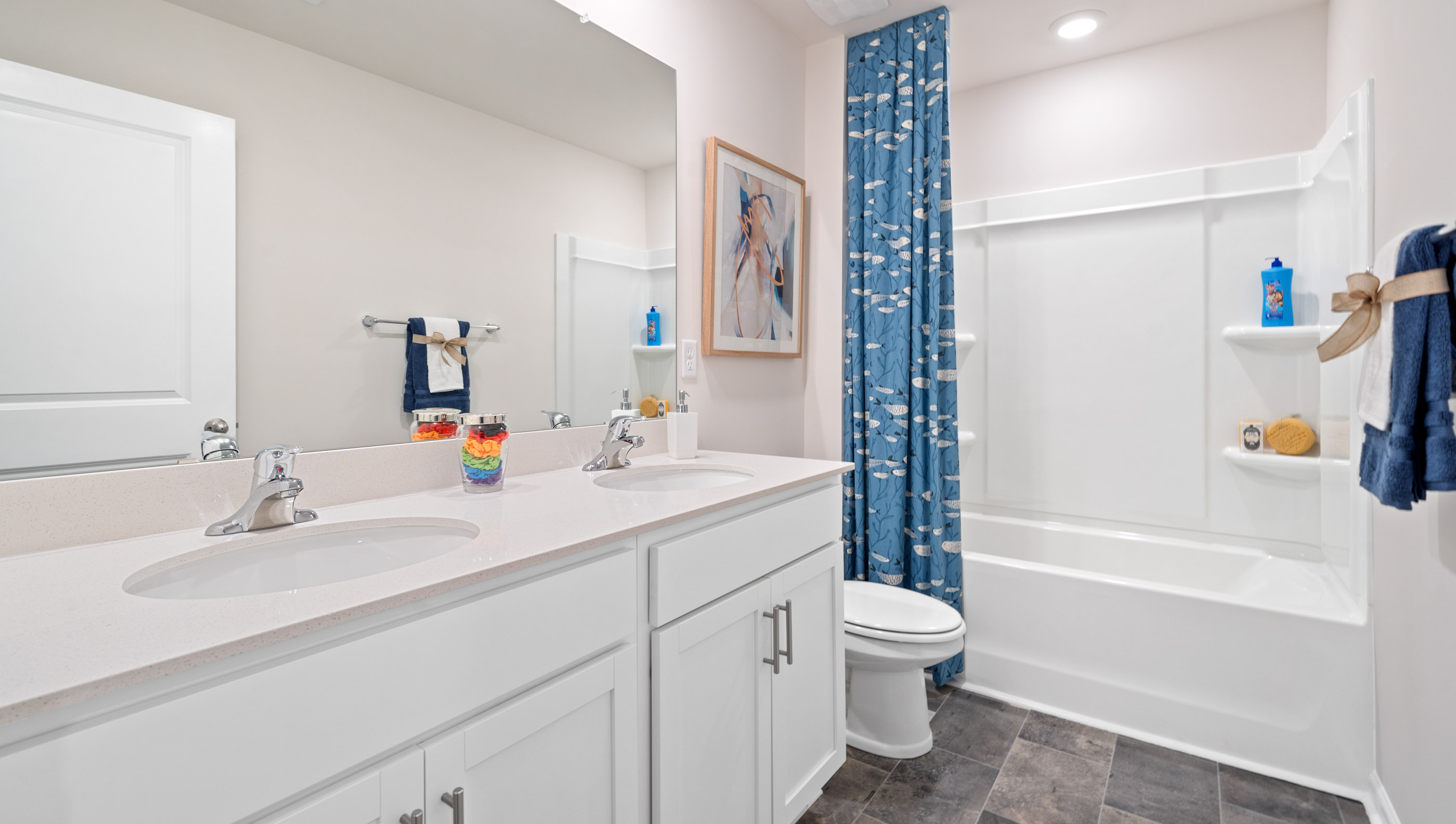 Double sink vanity with tub.