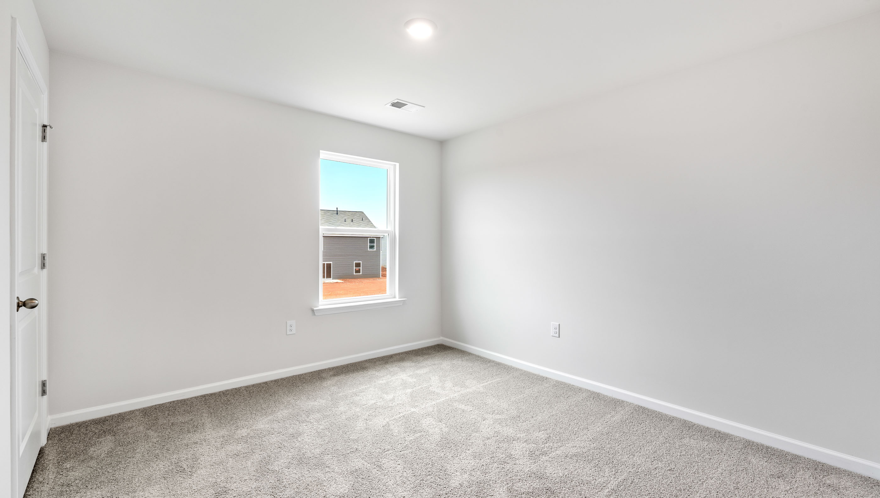 Bedroom with carpet and window.