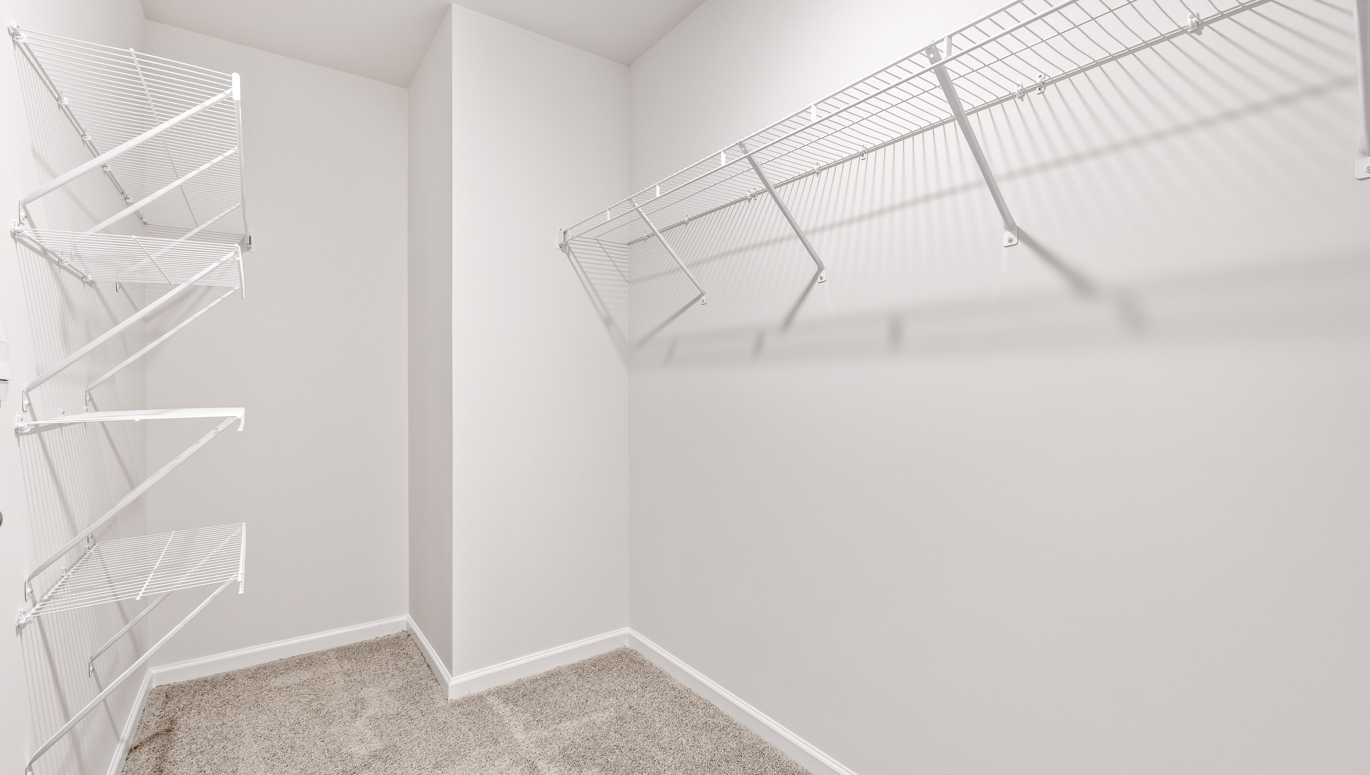 Walk in closet with hanging shelves.