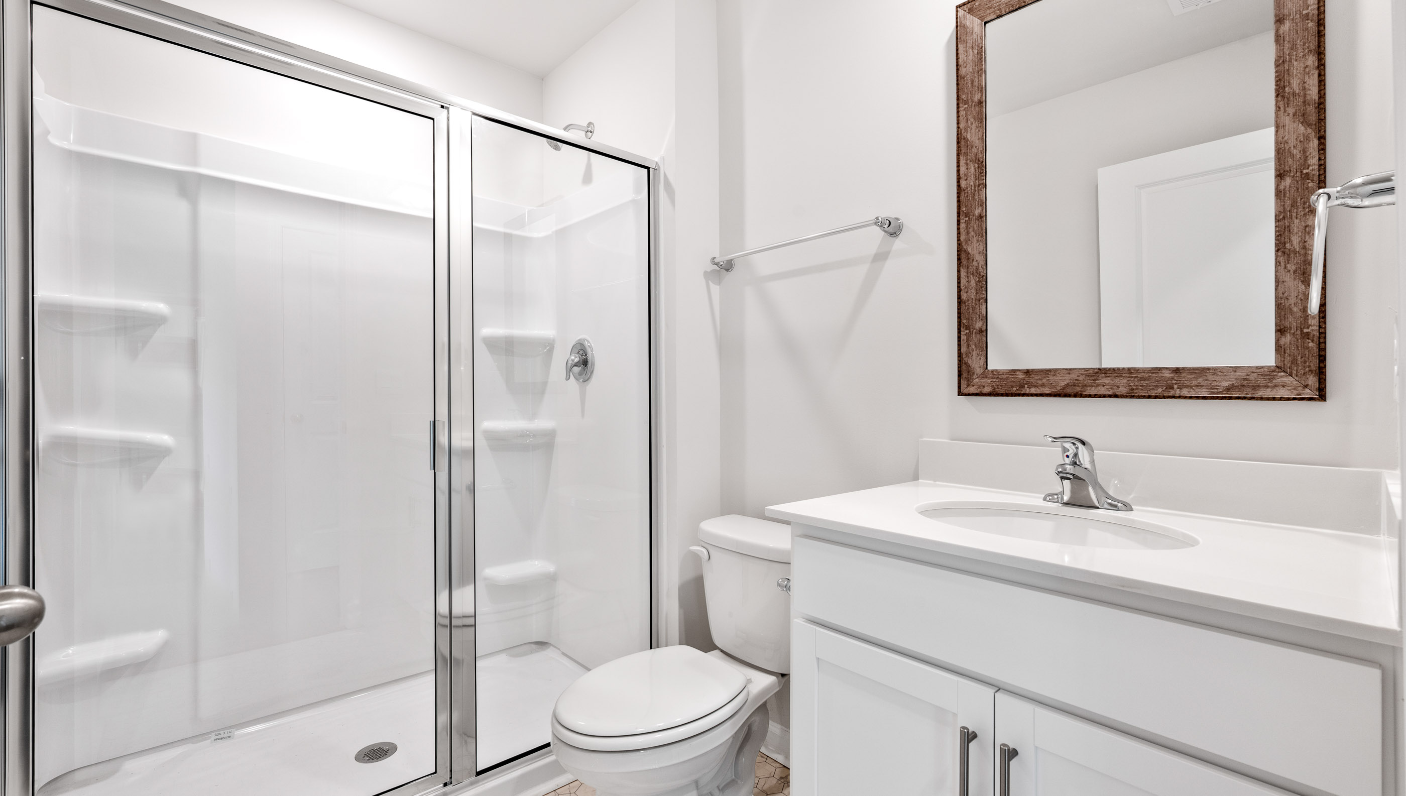 Bathroom with vanity and walk in shower.