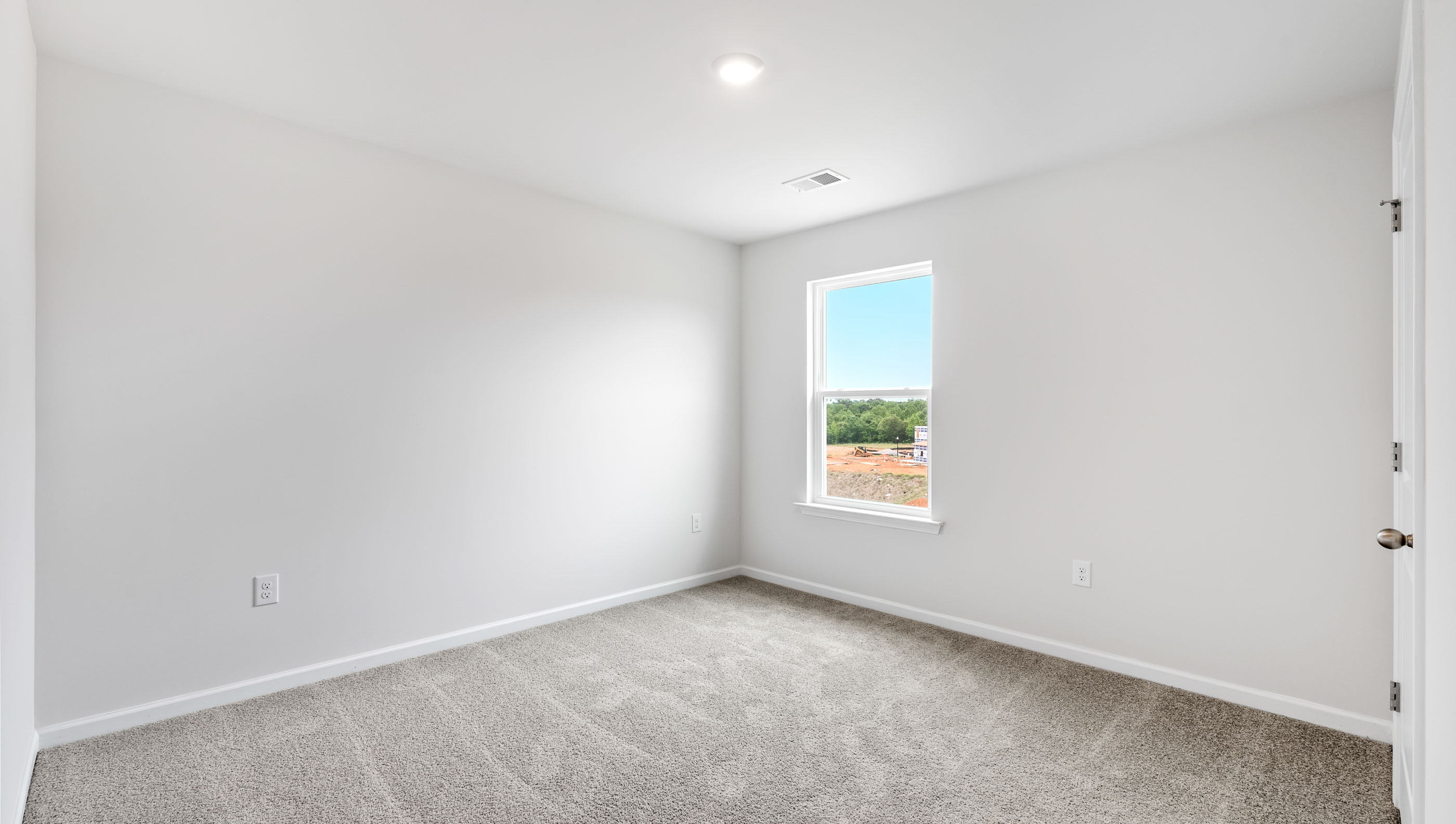 Bedroom with carpet and window.