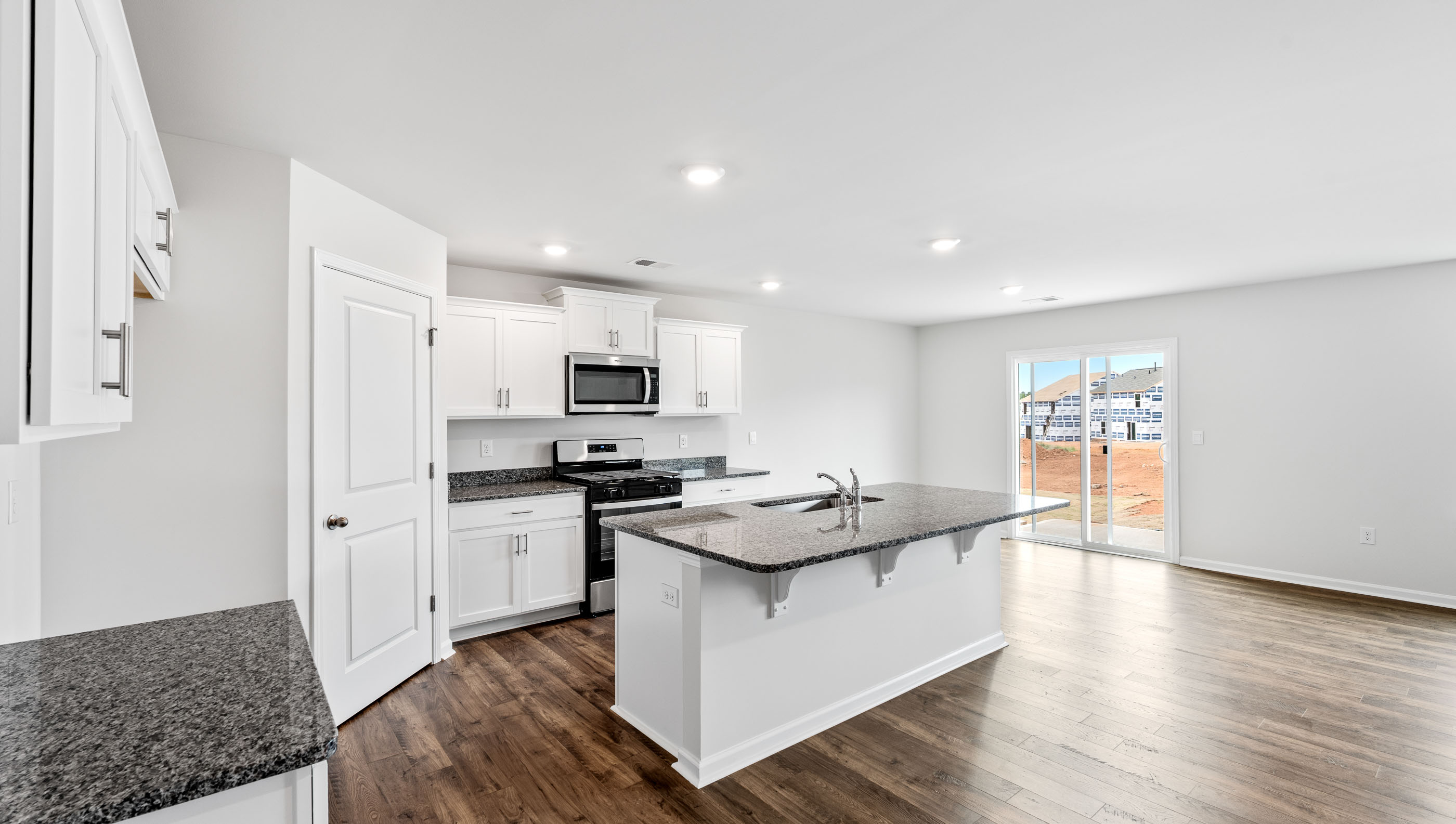 Kitchen and island with granite countertops.