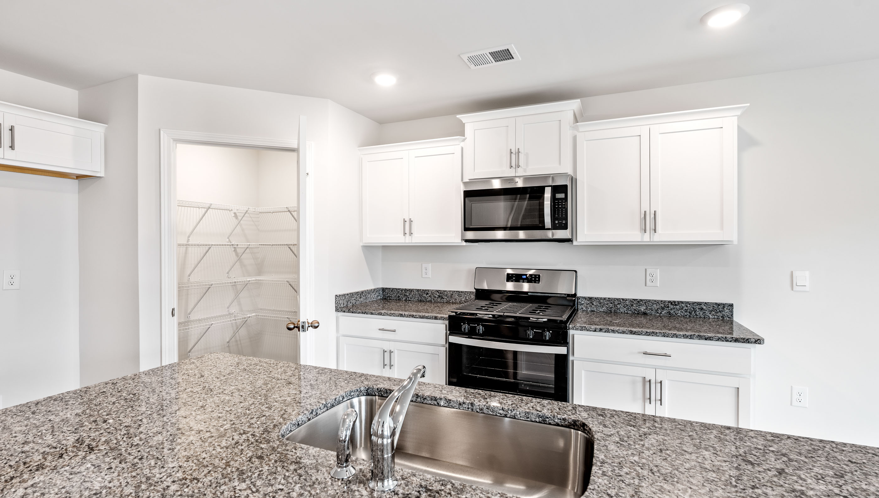 Kitchen and island with granite countertops.