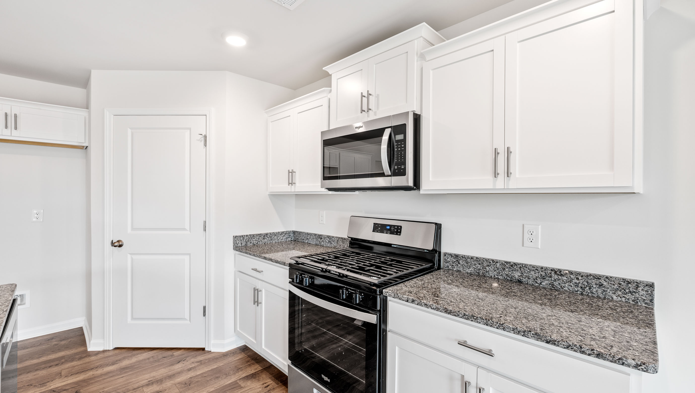 Kitchen with granite countertops and stainless steel appliances.