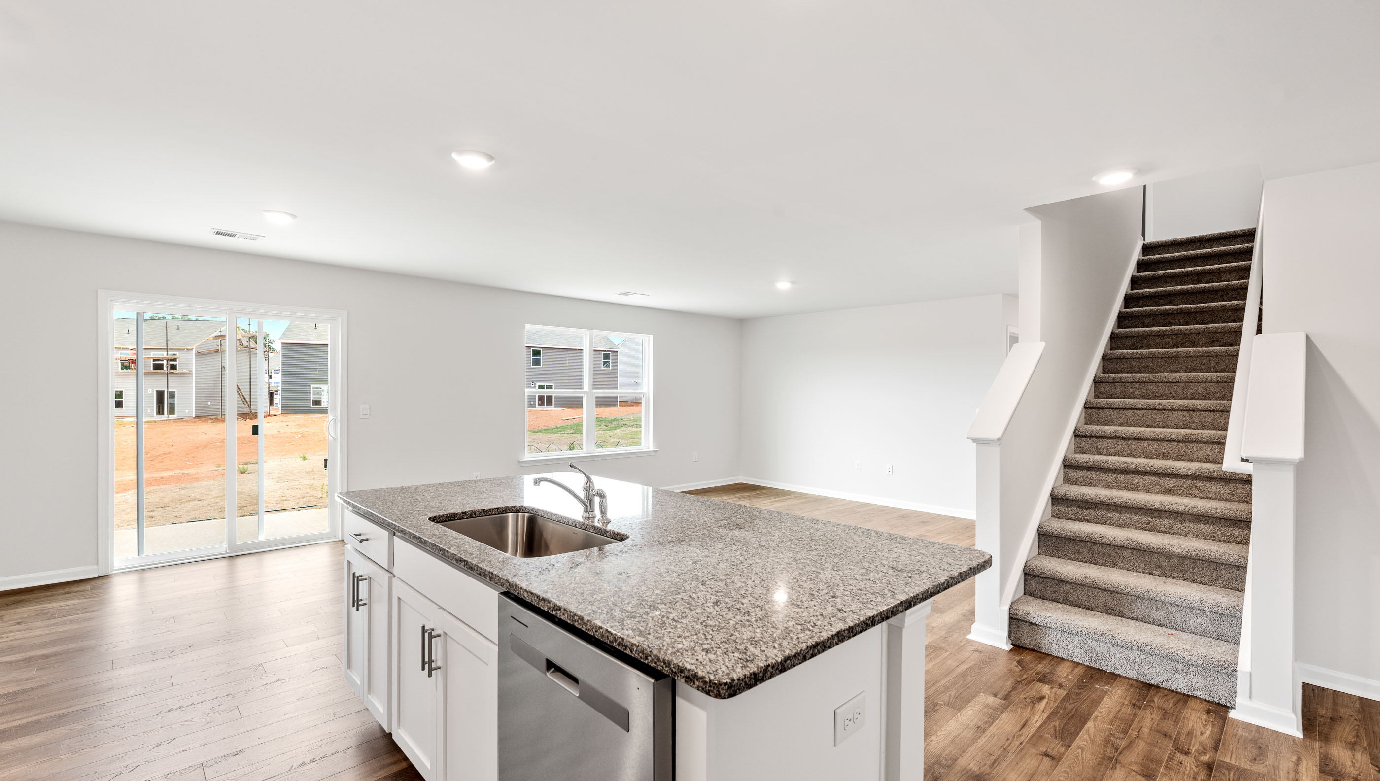 Kitchen looking towards dining room with windows.
