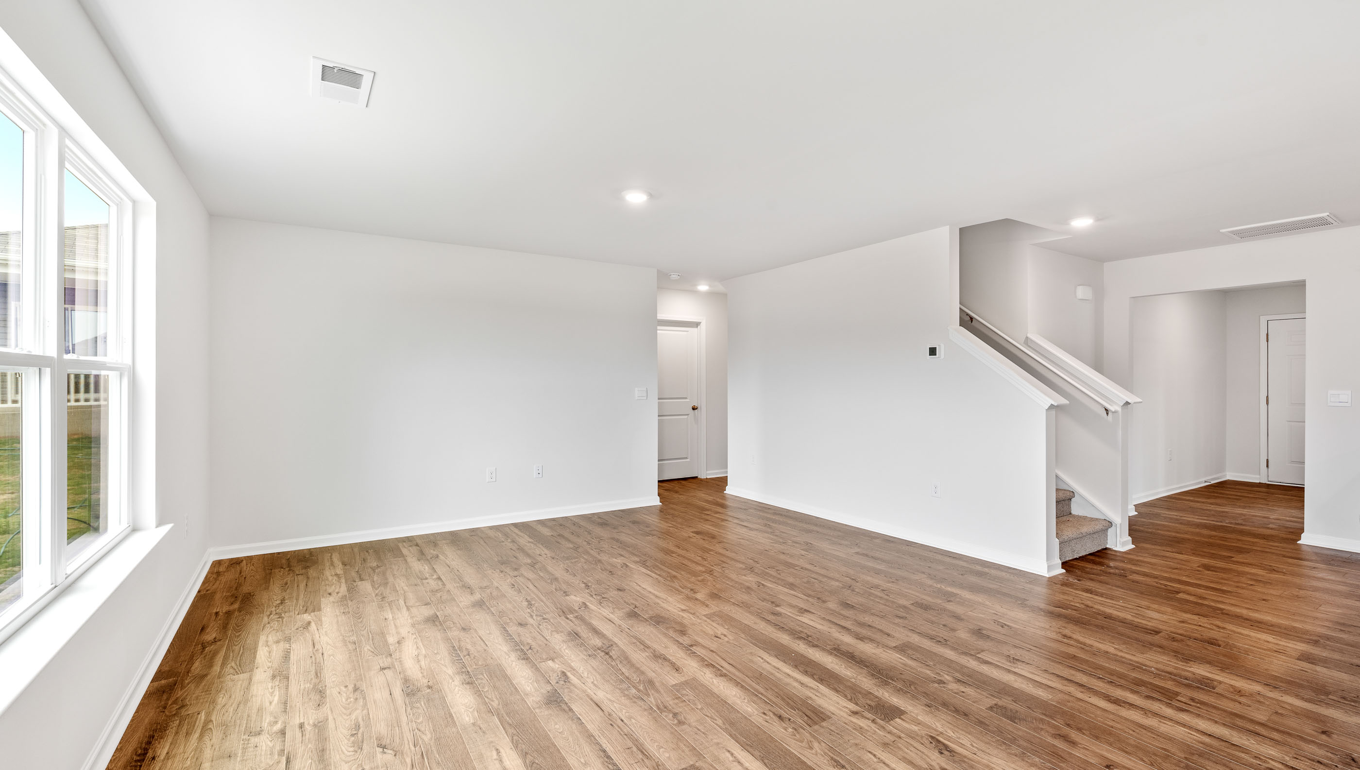 Dining room with windows looking towards living room.