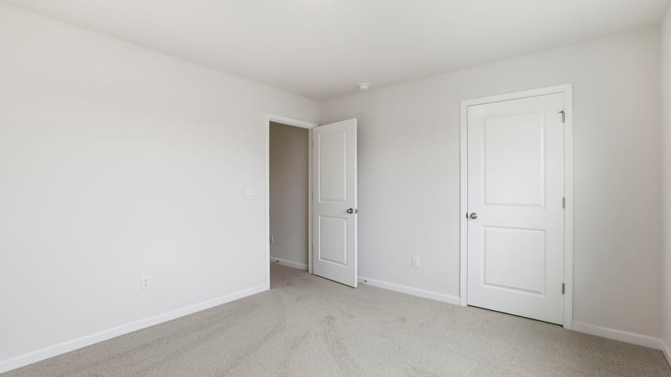 Bedroom with carpet and window.