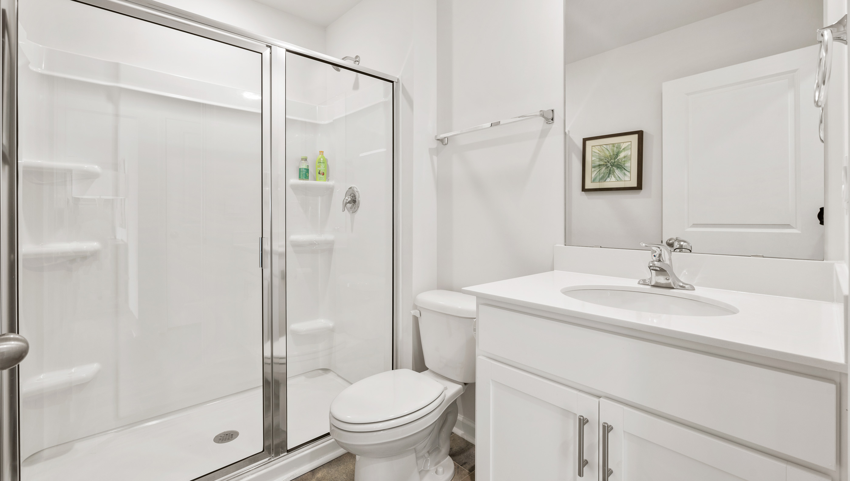 Bathroom with vanity and walk in shower.