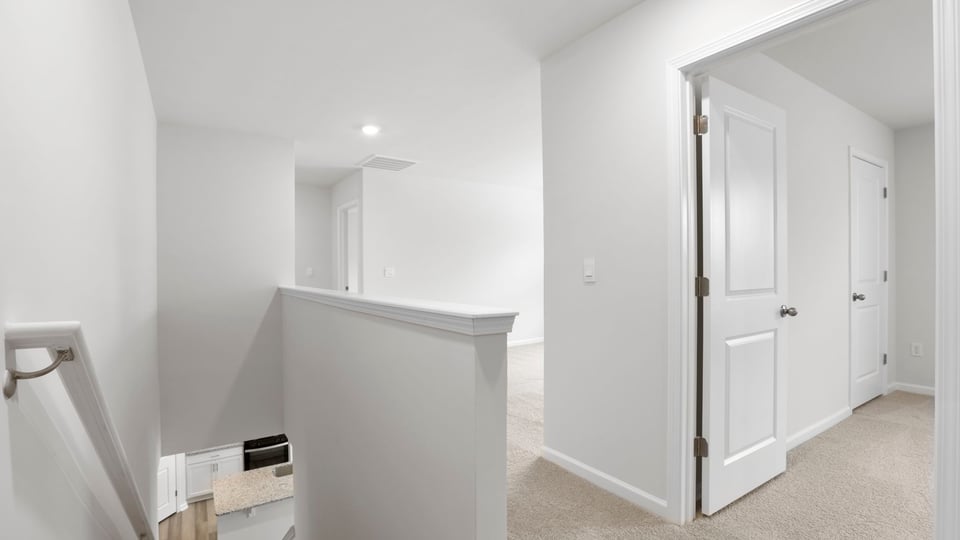 Upstairs landing area with carpet.