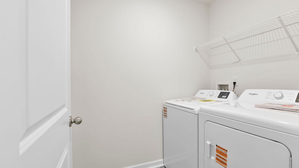Walk in laundry room with shelving.
