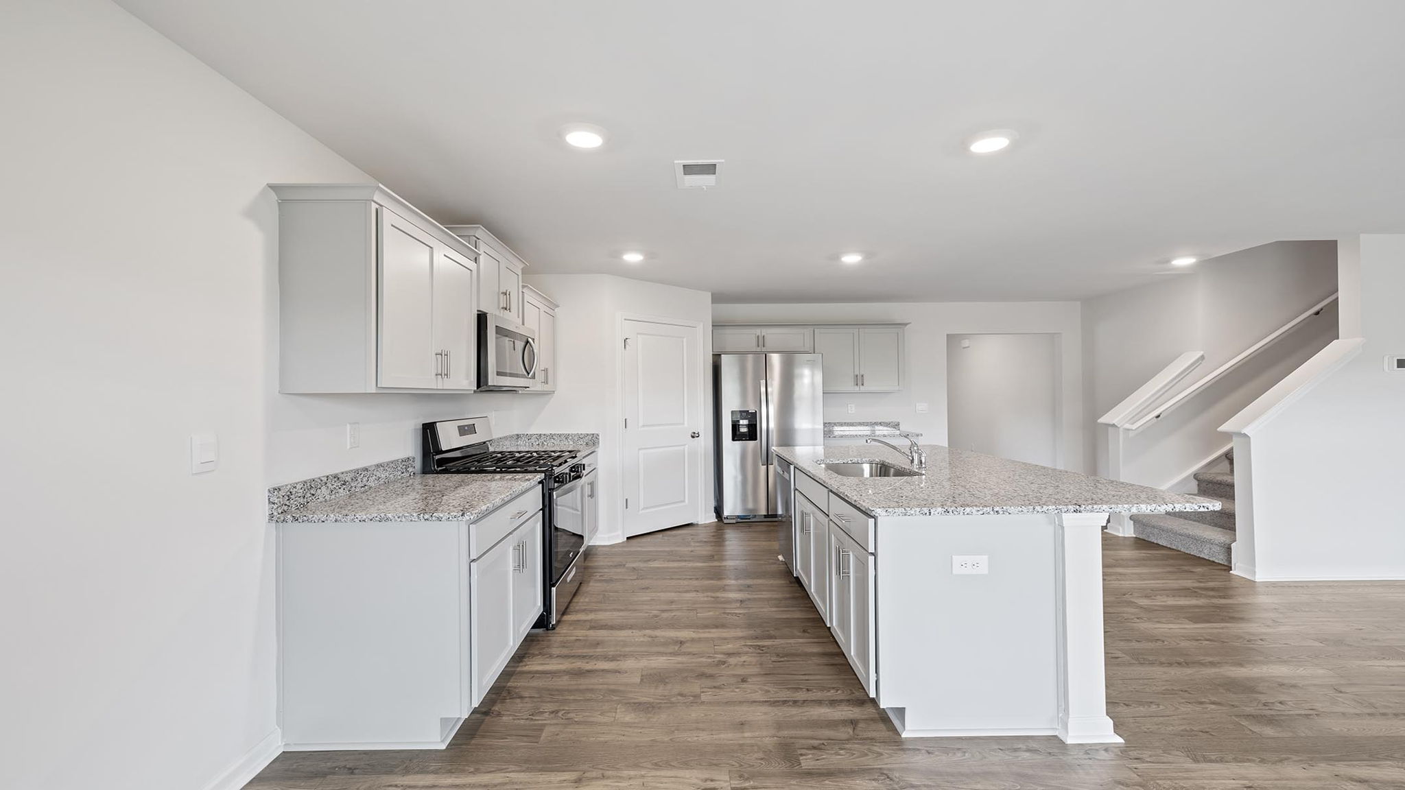 Kitchen and island with granite countertops.