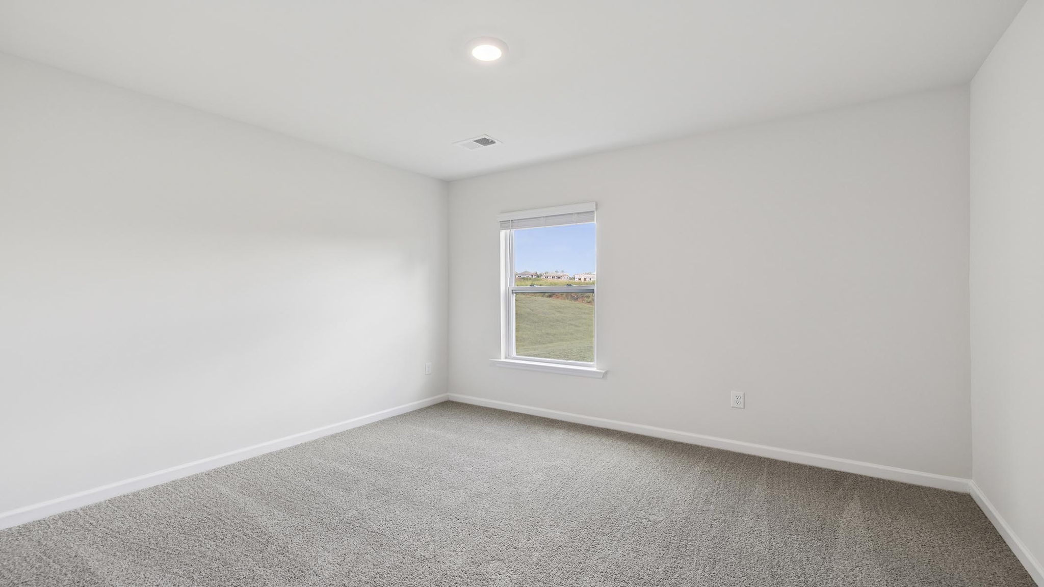 Bedroom with carpet and window.