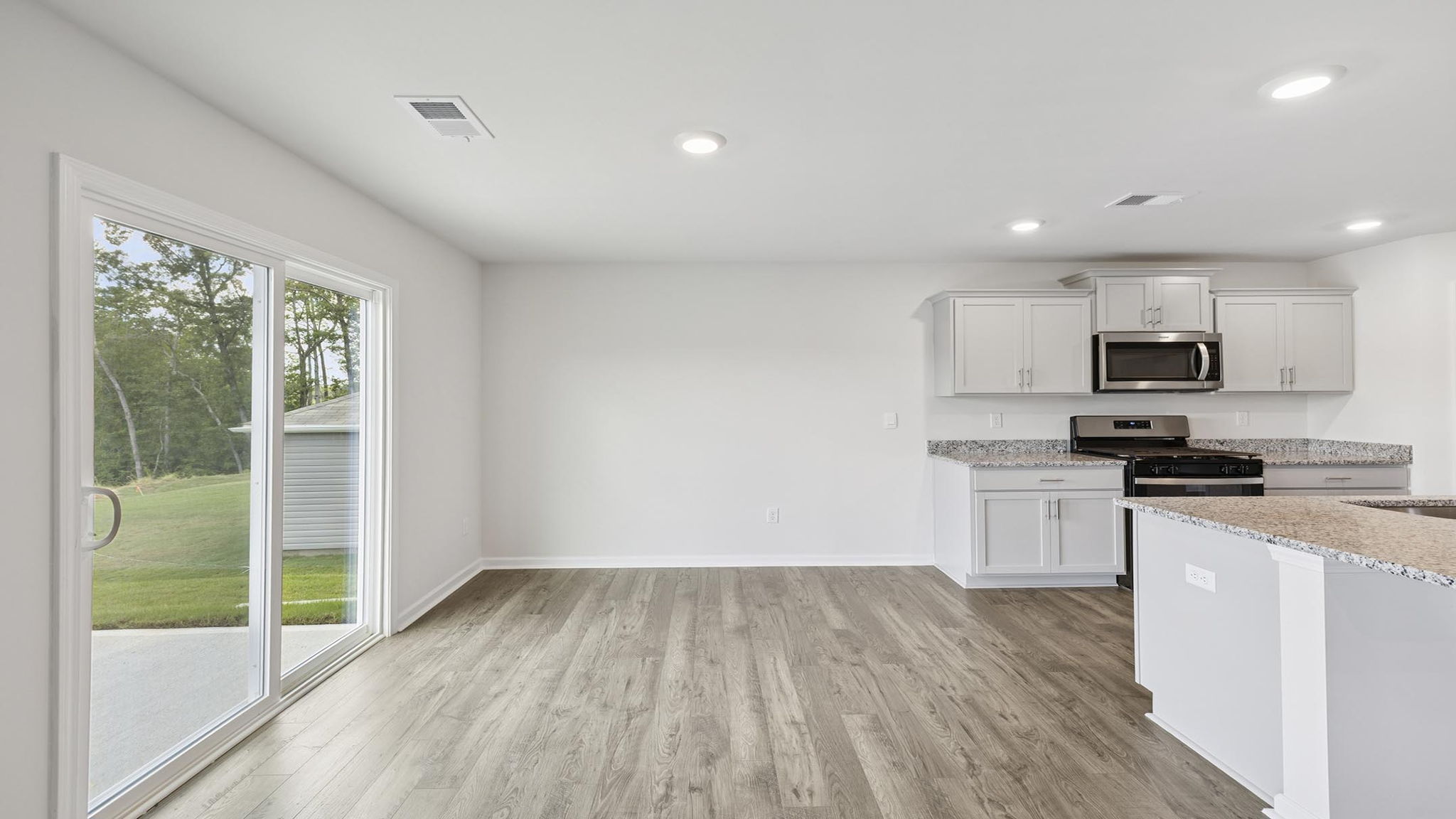 Kitchen and island with granite counter tops.