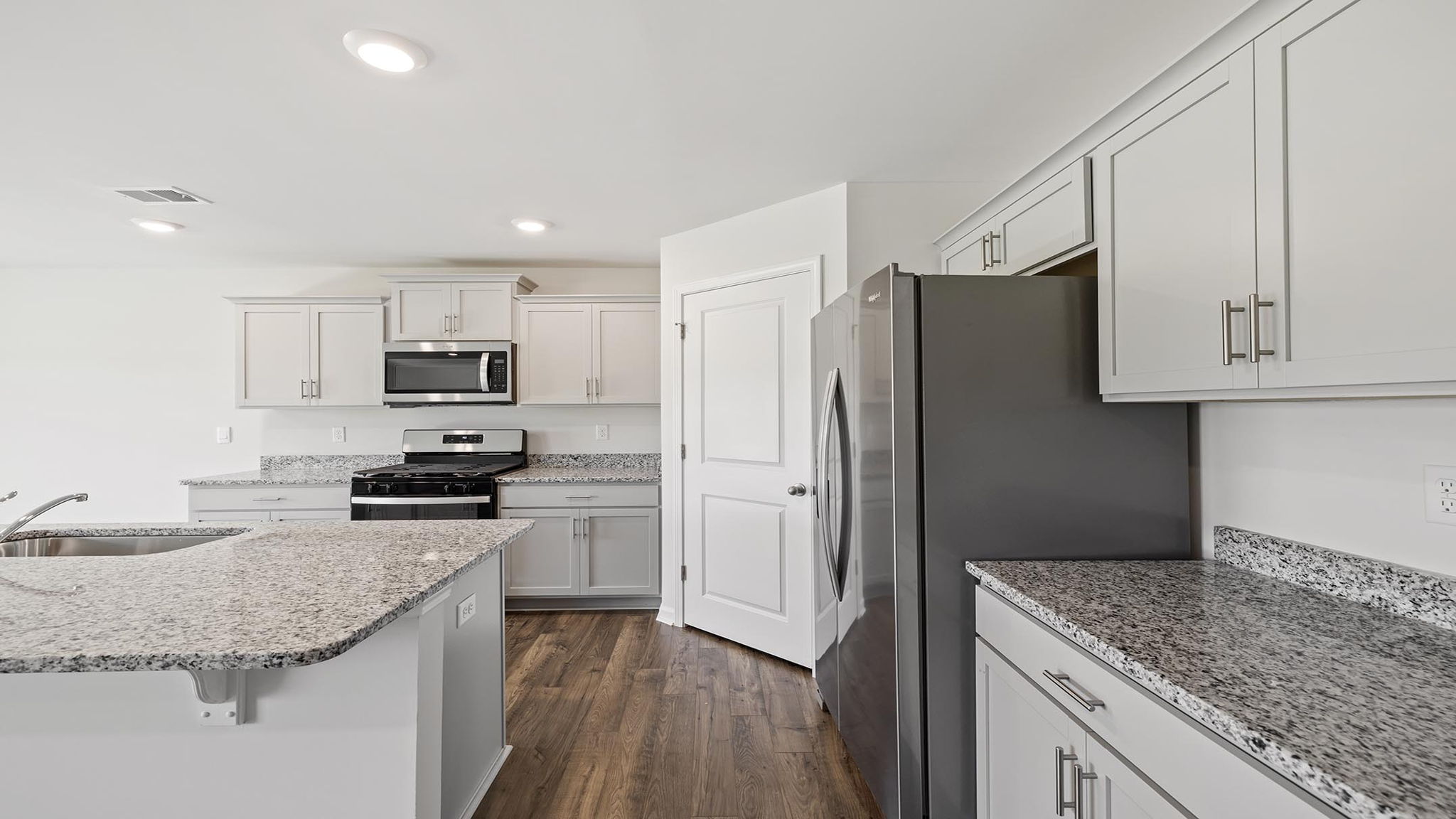 Kitchen and island with granite counter tops.