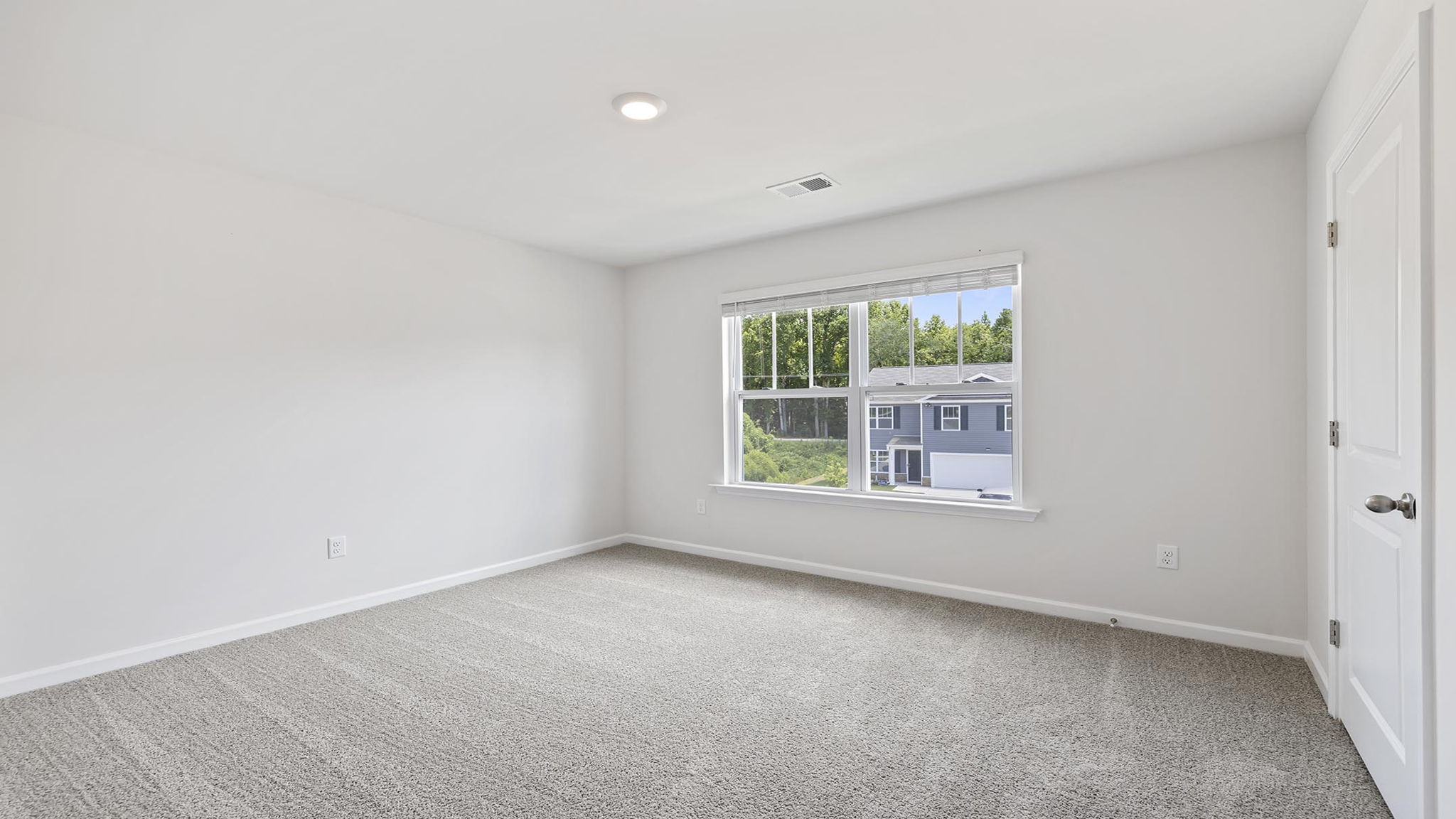 Bedroom with caret and window.