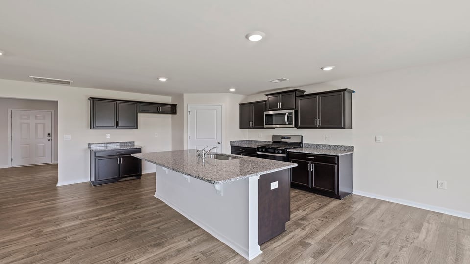 Kitchen and island with granite countertops.