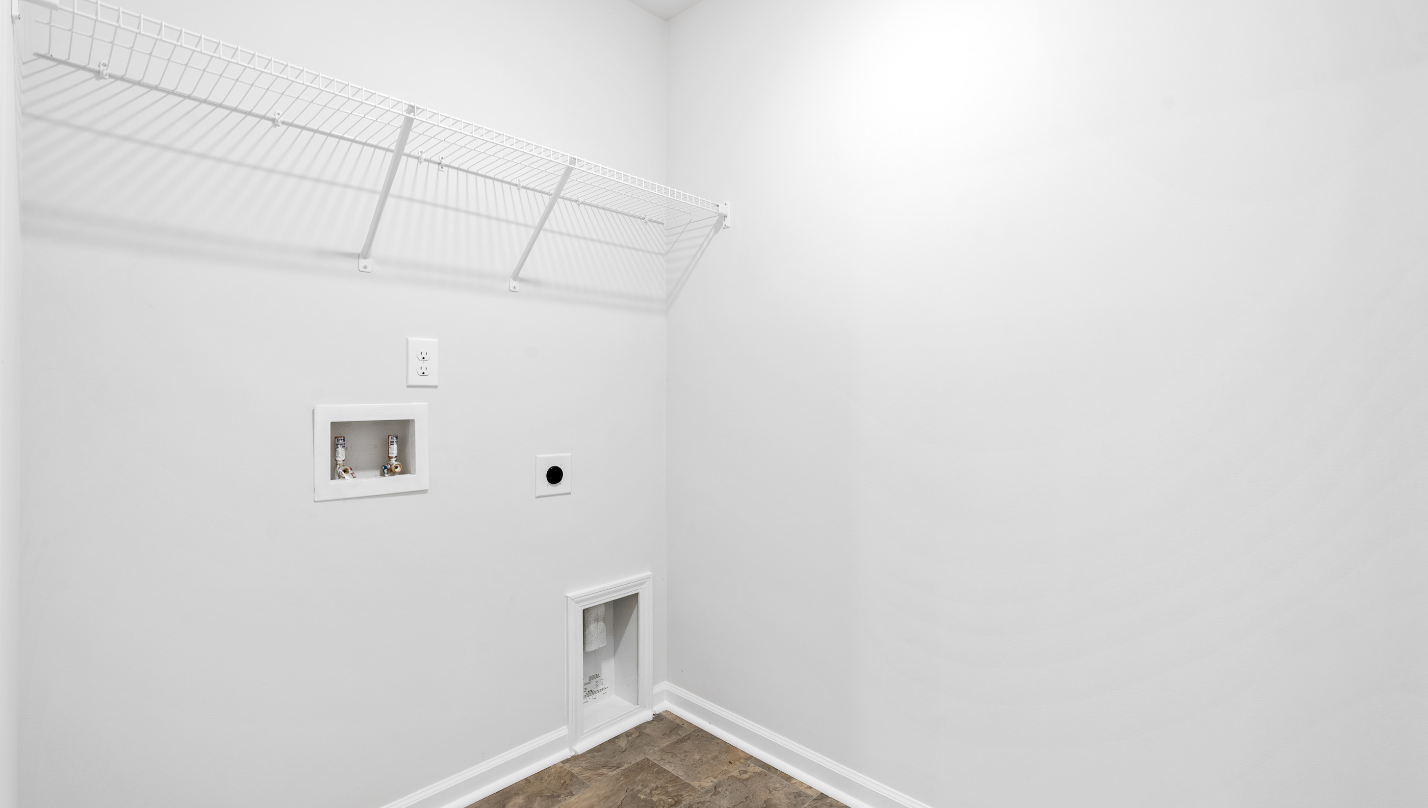 Walk in laundry with shelves.