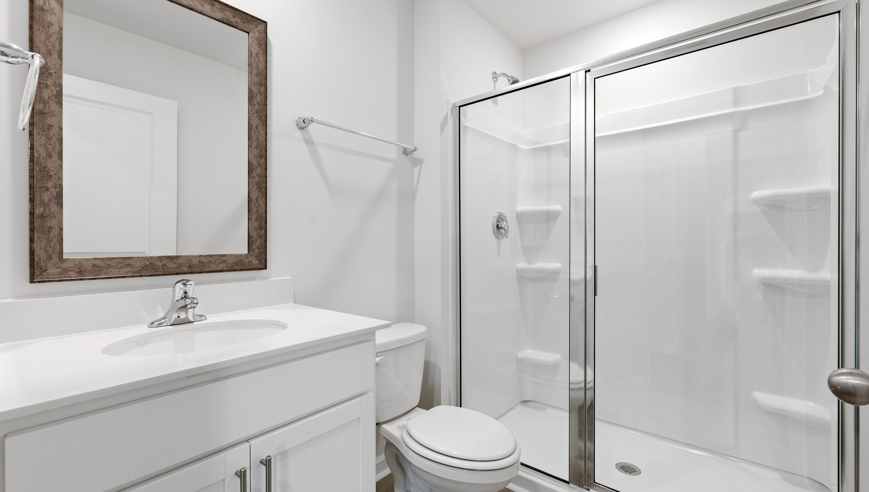 Bathroom with vanity and shower.