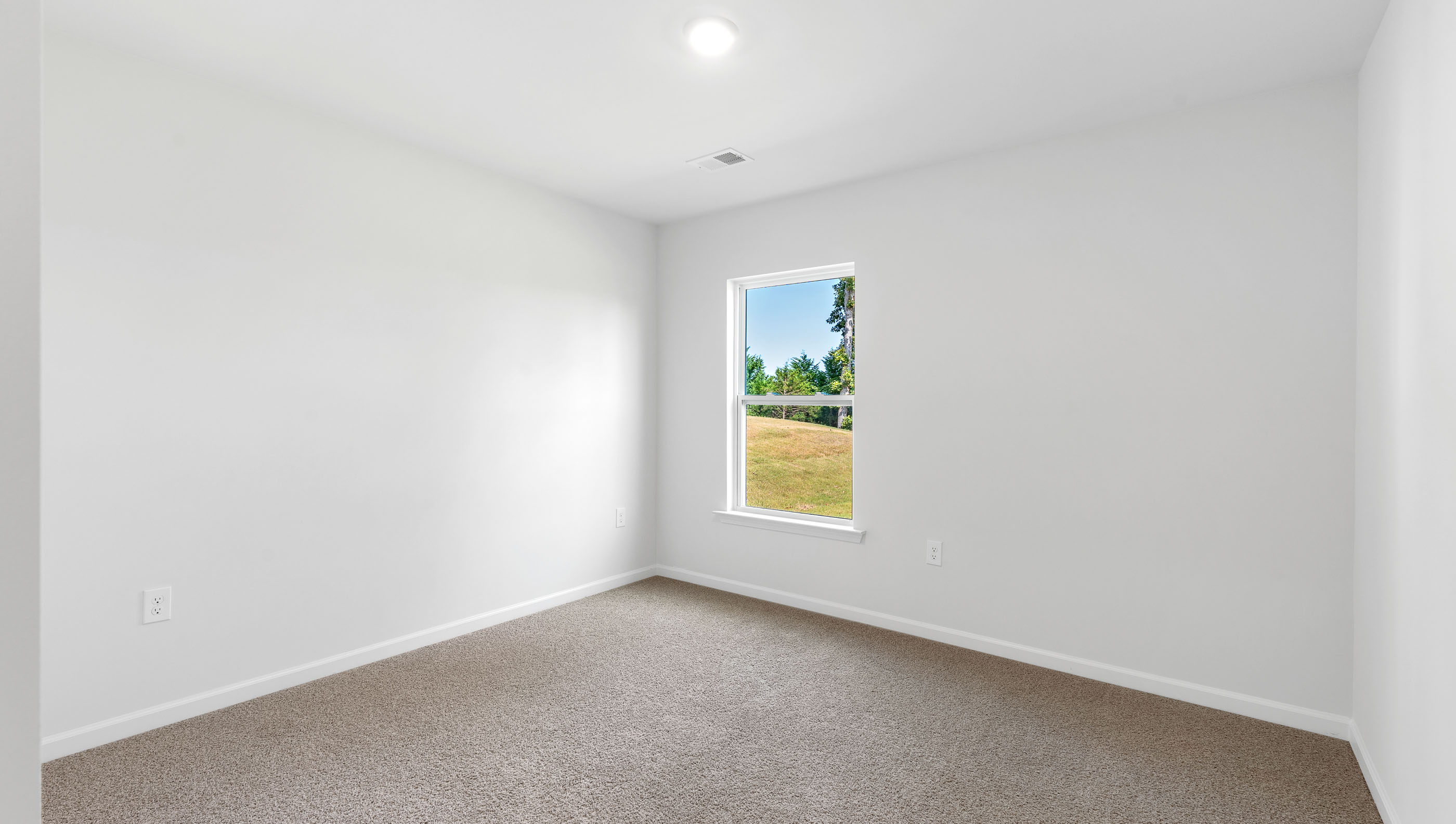 Bedroom with carpet and windows.
