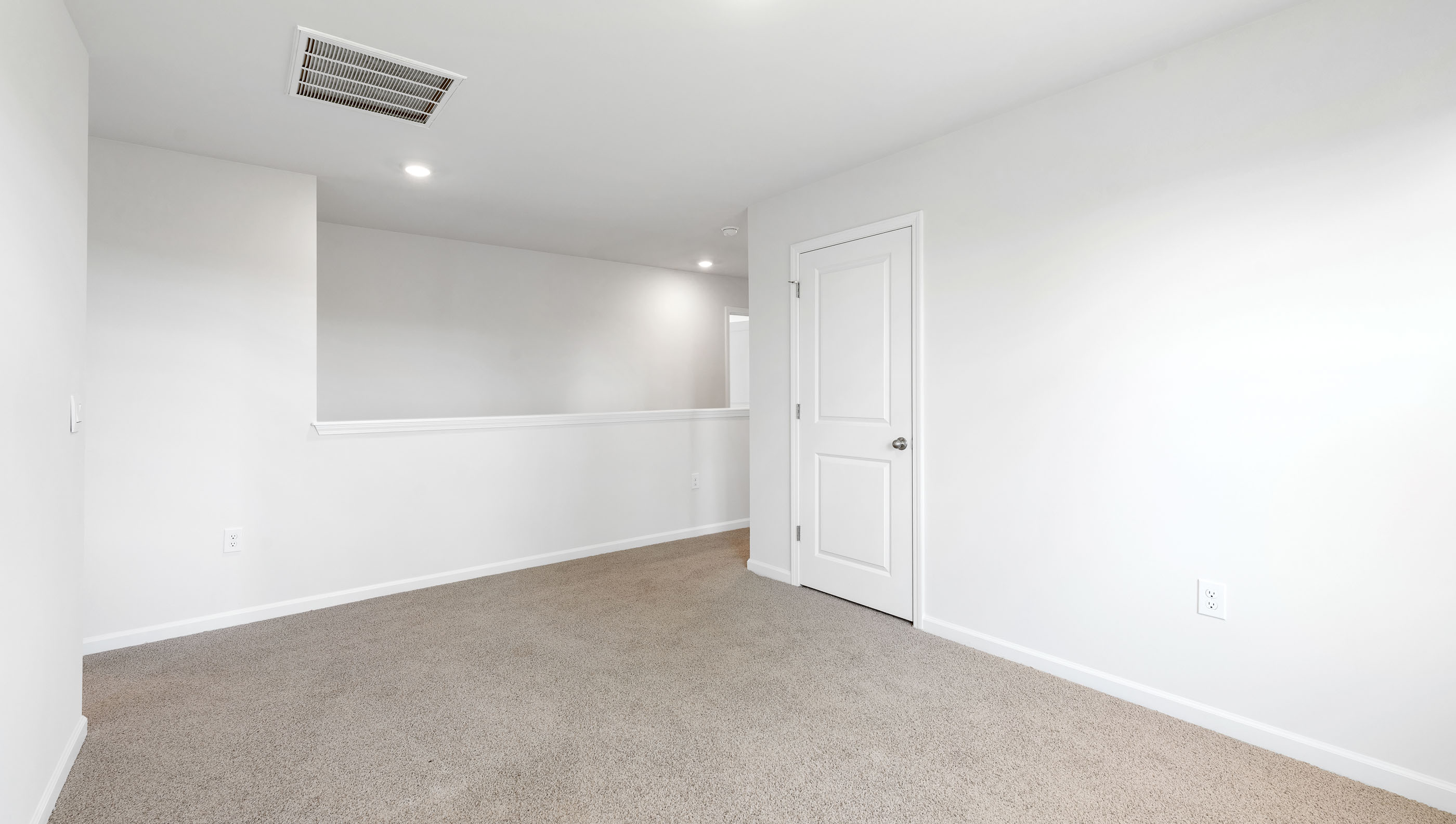 Upstairs loft area with carpet.