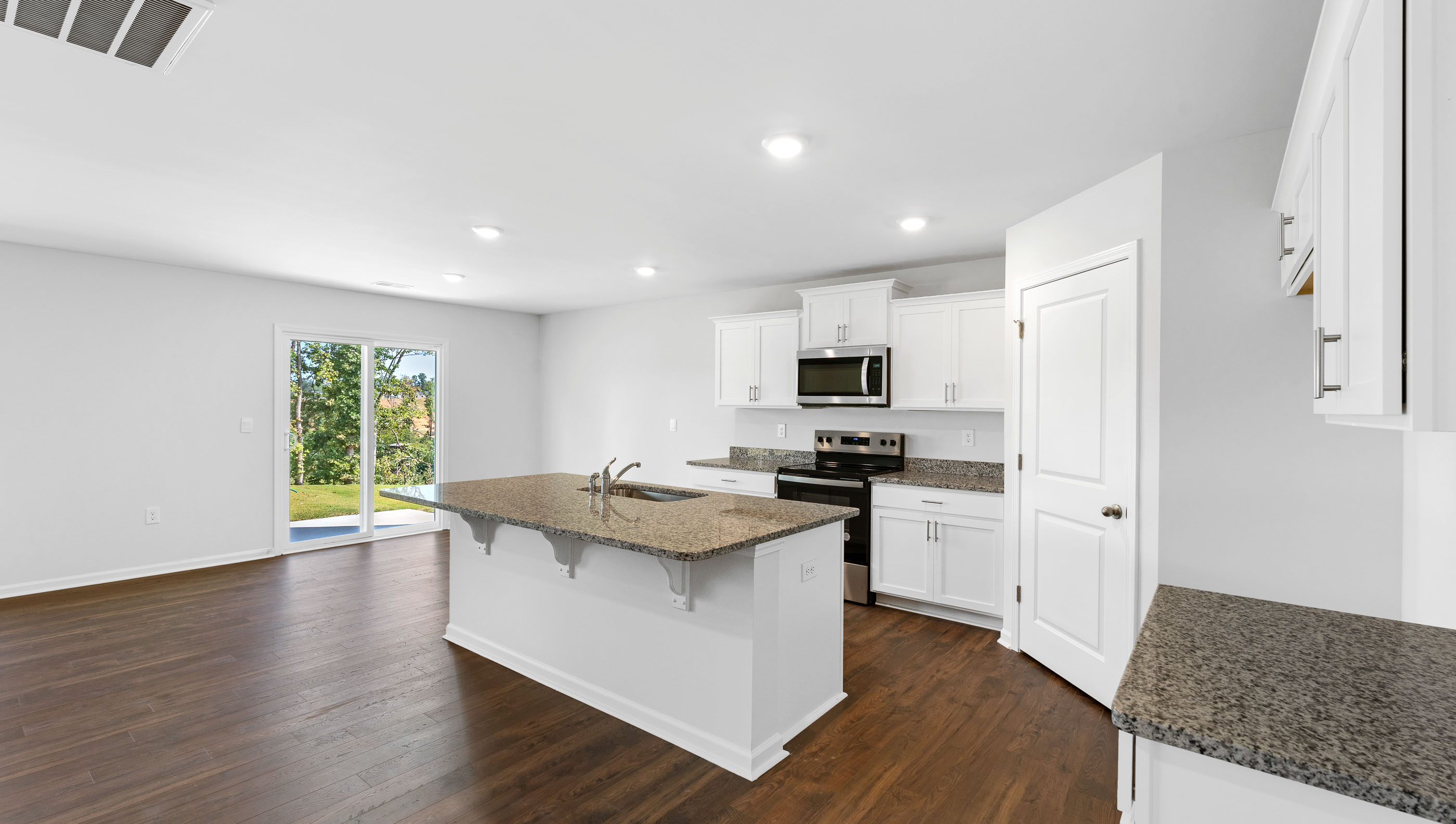 Kitchen and island with granite countertops.