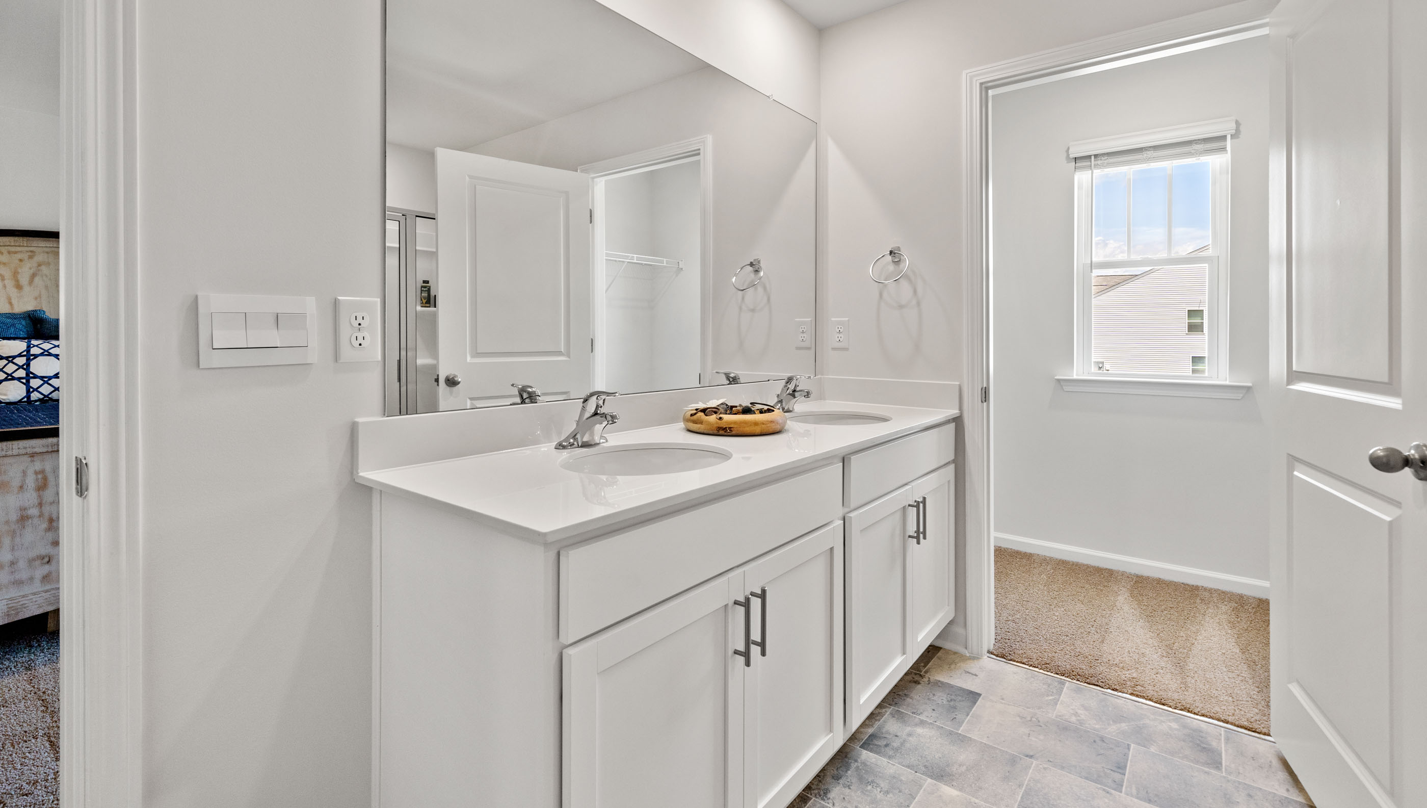 Double sink vanity in primary bathroom.
