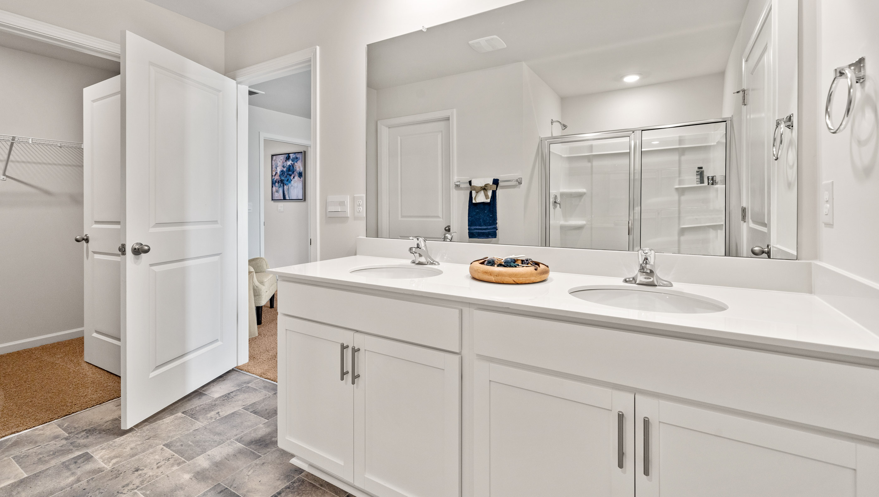 Double sink vanity in primary bathroom.